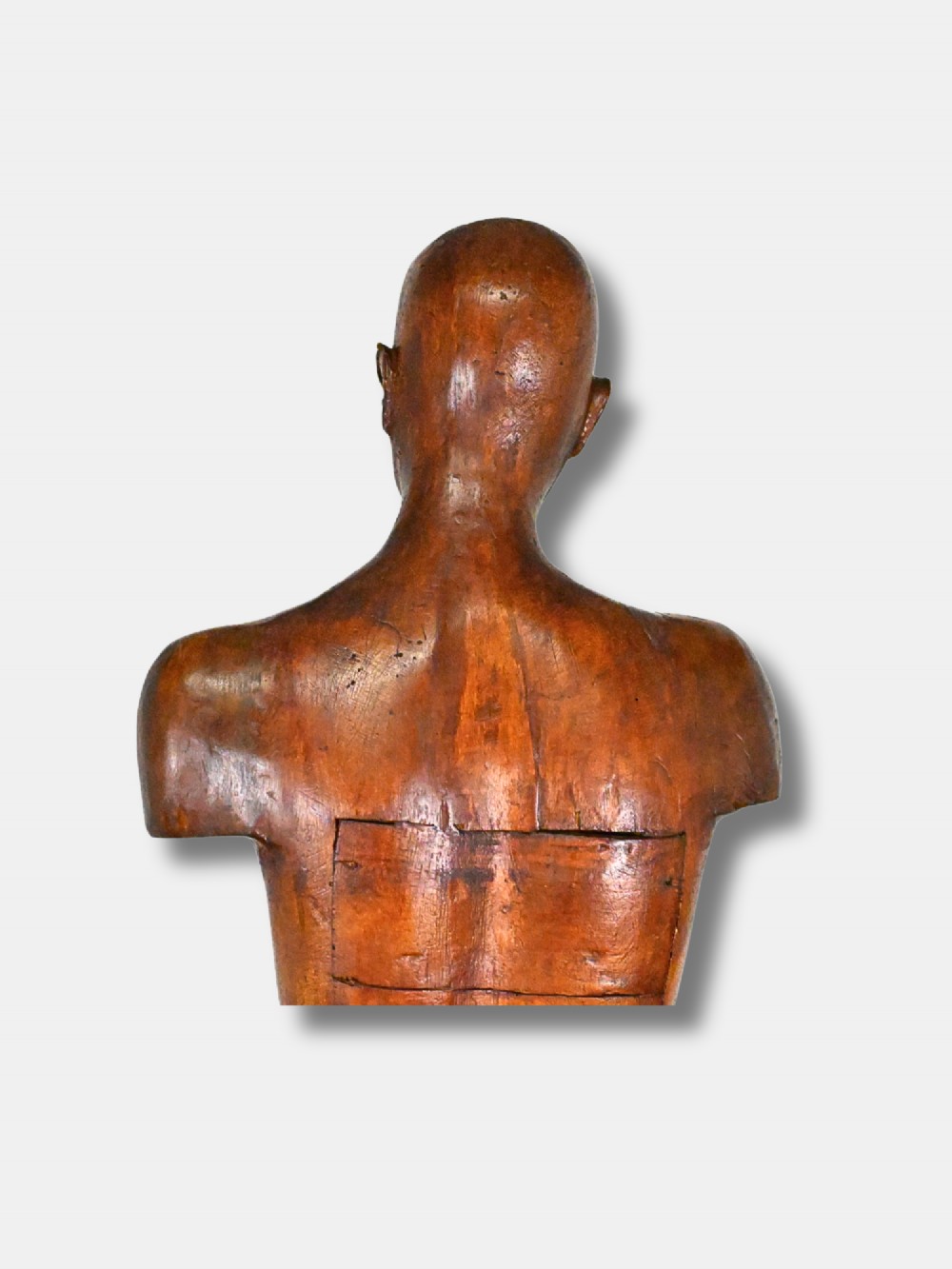 An 18th-century carved wood male figure standing on a square stepped wooden plinth. View III