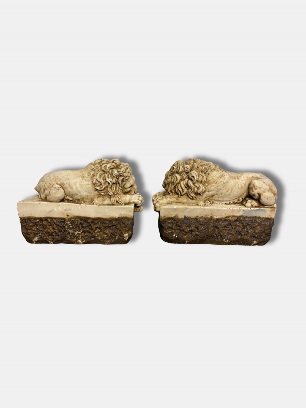 A pair of late nineteenth-century carved alabaster lion sculptures depicted resting atop rustic stone bases, after Antonio Canova. View III