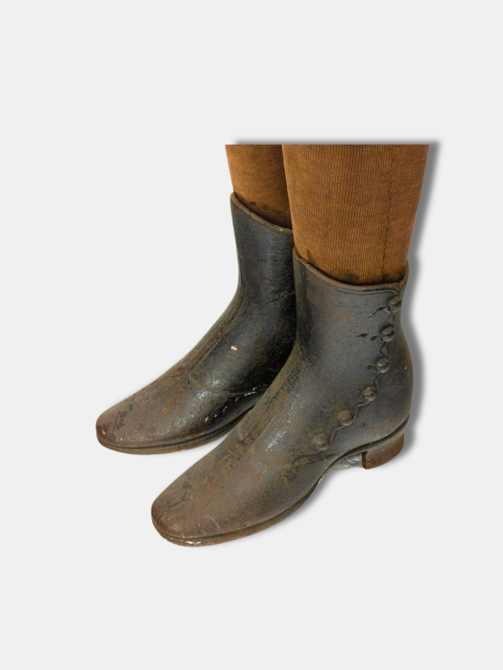 A full-length 19th-century French childs display mannequin upholstered in tan canvas, supported by cast iron boots and topped with a brass neck collar. View III