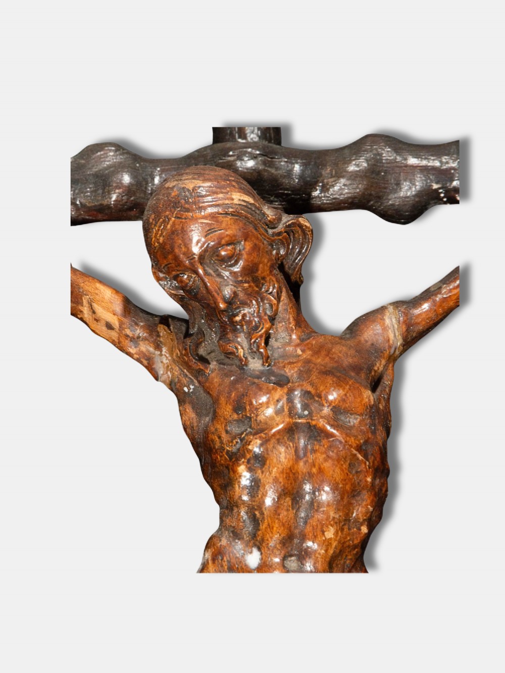 An 18th-century Spanish carved wooden crucifix depicting Jesus Christ on a rustic timber cross. View II