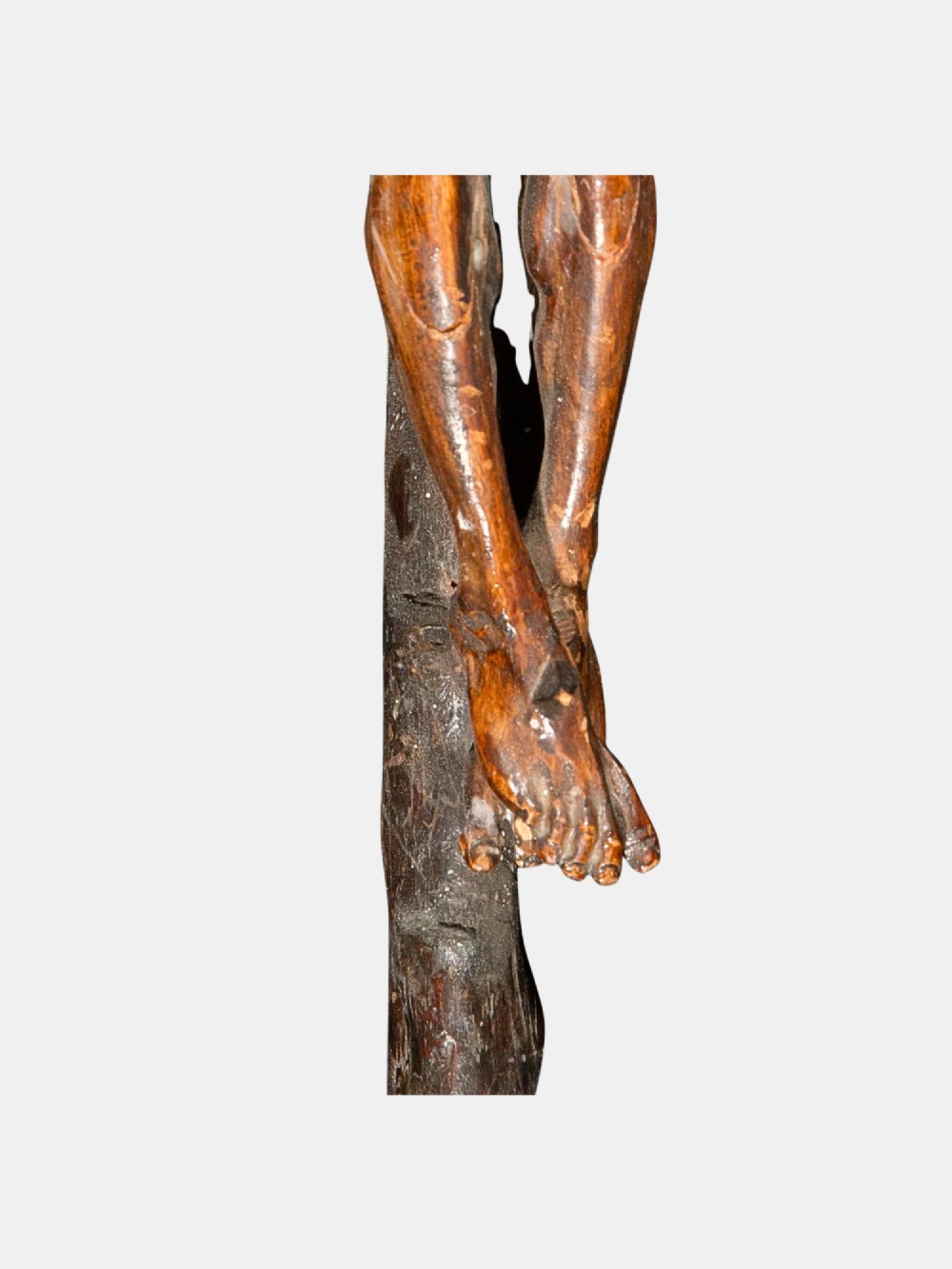 An 18th-century Spanish carved wooden crucifix depicting Jesus Christ on a rustic timber cross. View IV