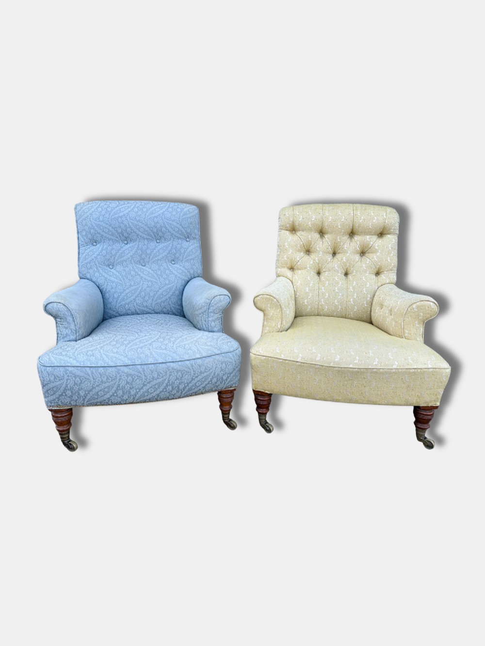 A Victorian armchair upholstered in pale yellow patterned fabric featuring a deep-buttoned backrest, scrolled armrests, and turned wood legs with brass castors. View VIII