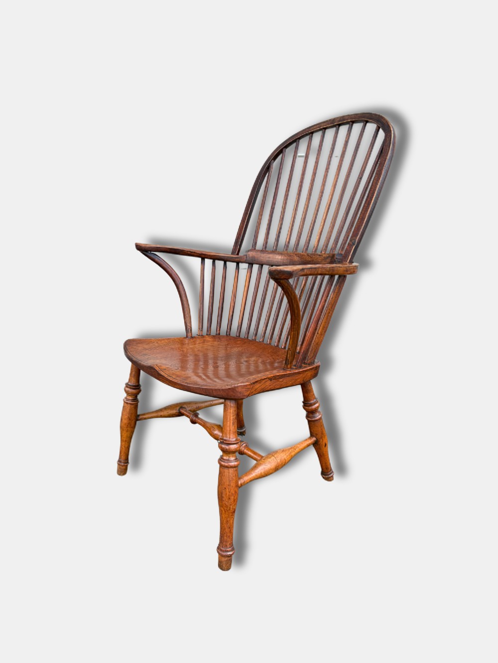 A nineteenth-century English stickback Windsor armchair made of ash and elm with turned legs, an H-stretcher, and a shaped saddle seat. View III