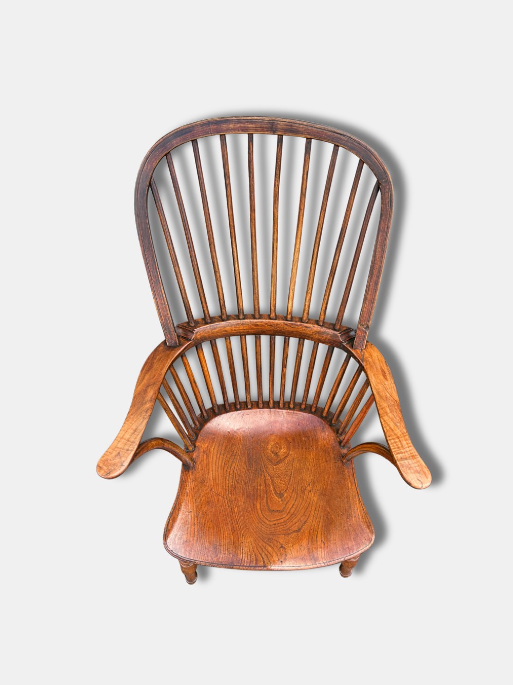 A nineteenth-century English stickback Windsor armchair made of ash and elm with turned legs, an H-stretcher, and a shaped saddle seat. View IV