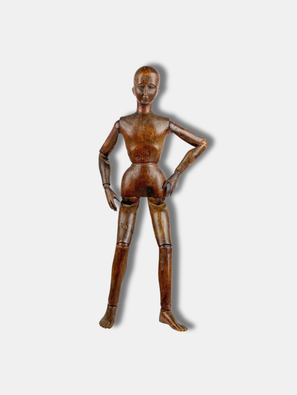 A French carved wooden articulated artist lay figure with a warm brown finish and posable limbs.