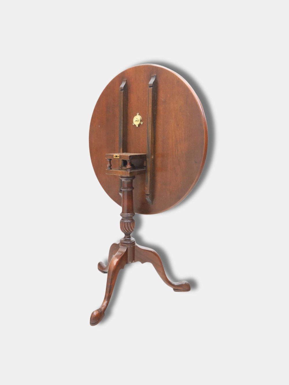 An early 20th-century Georgian style tripod table with a circular burr walnut tilt top raised on a turned column with cabriole legs and pad feet. View IV