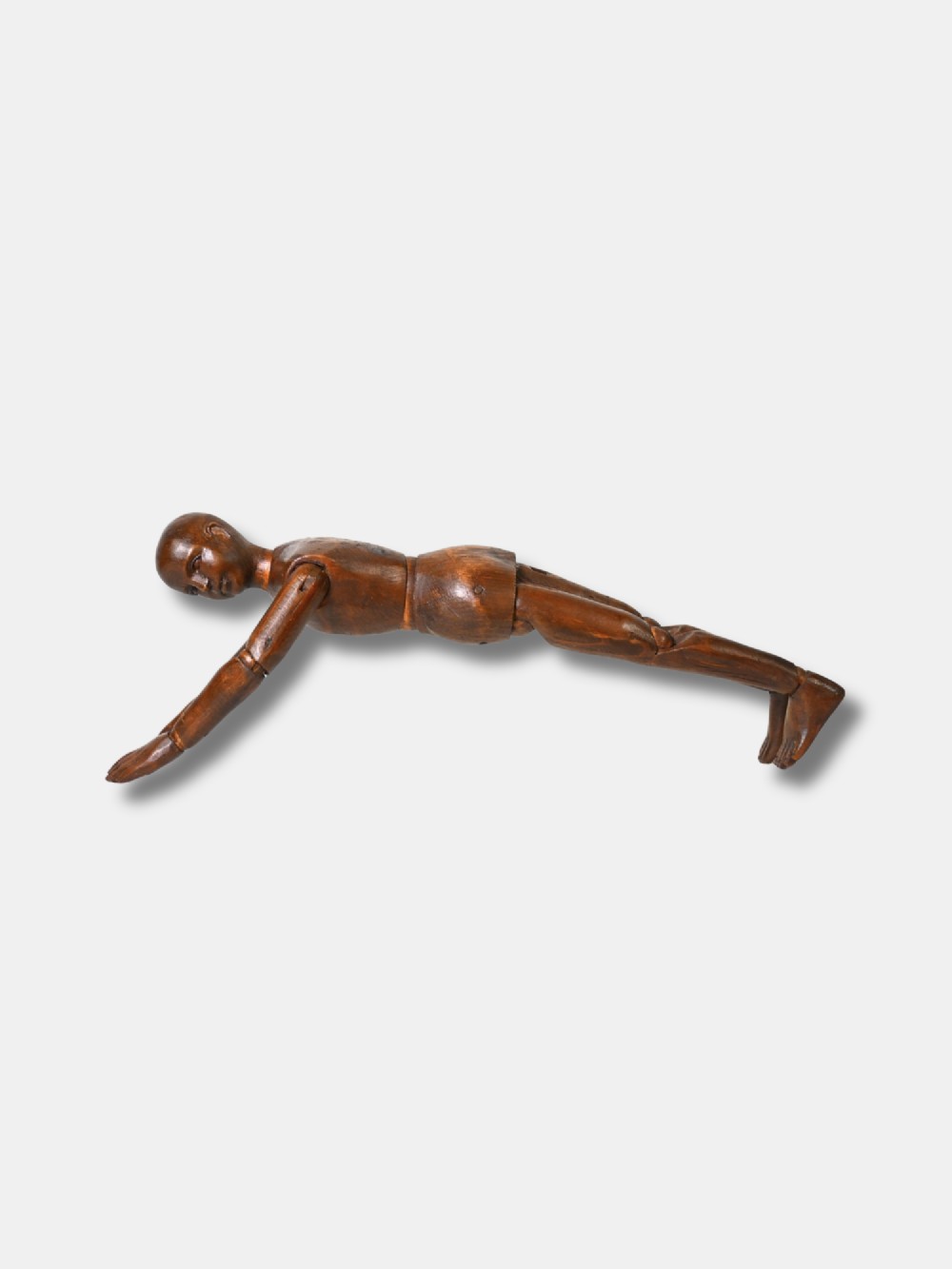 A French carved wood artist lay figure from circa 1890 with fully articulated limbs and a warm brown polished finish shown in a seated posture. View VI