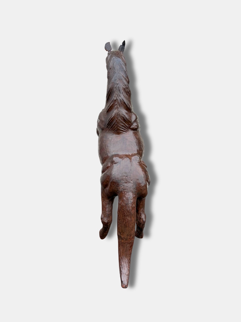 A large dark brown leather rearing horse sculpture crafted with muscular detailing, mane, and tail. View III
