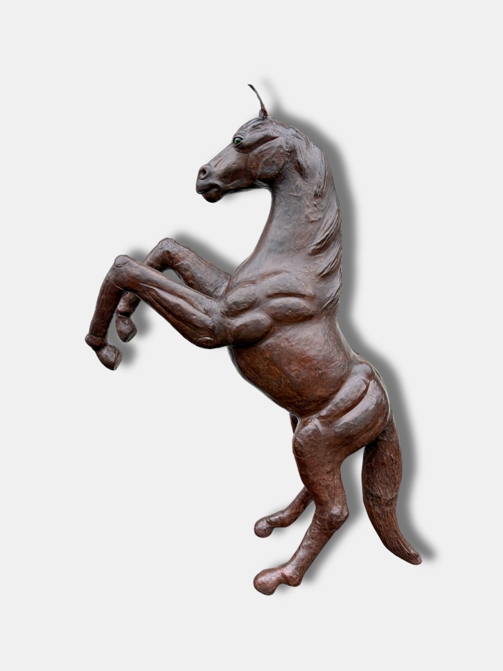 A large dark brown leather rearing horse sculpture crafted with muscular detailing, mane, and tail. View IV