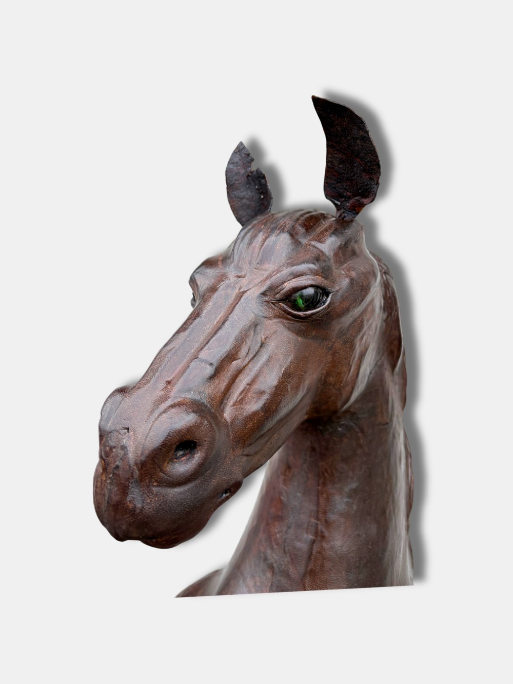 A large dark brown leather rearing horse sculpture crafted with muscular detailing, mane, and tail. View V