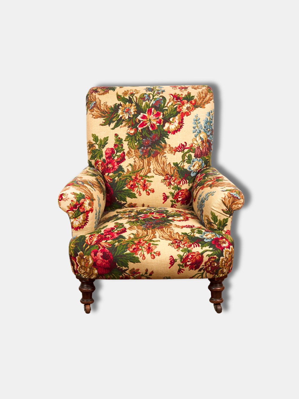 A Victorian mid-19th century armchair upholstered in cream floral fabric with turned dark timber front legs on brass castors. View II