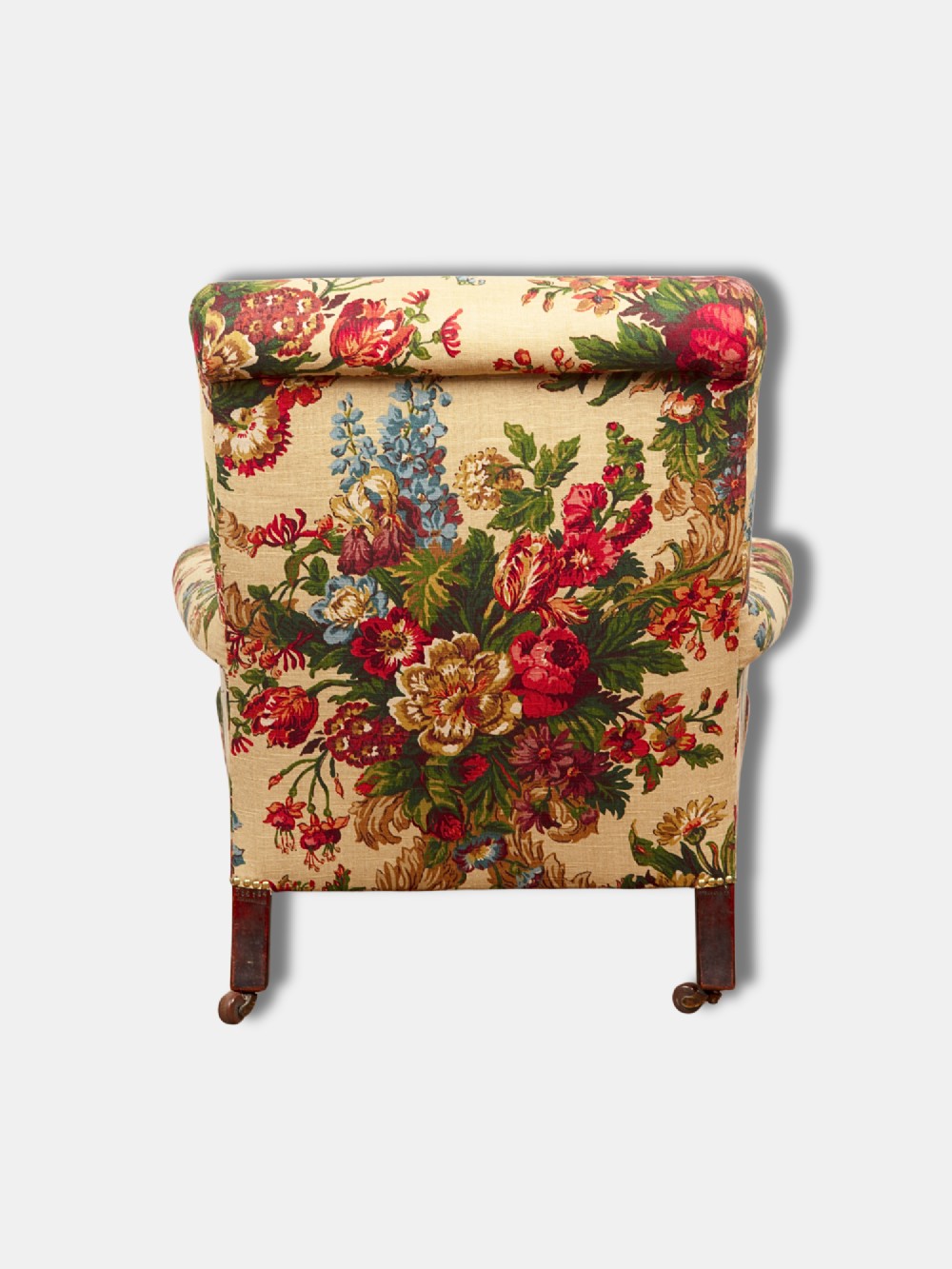 A Victorian mid-19th century armchair upholstered in cream floral fabric with turned dark timber front legs on brass castors. View IV