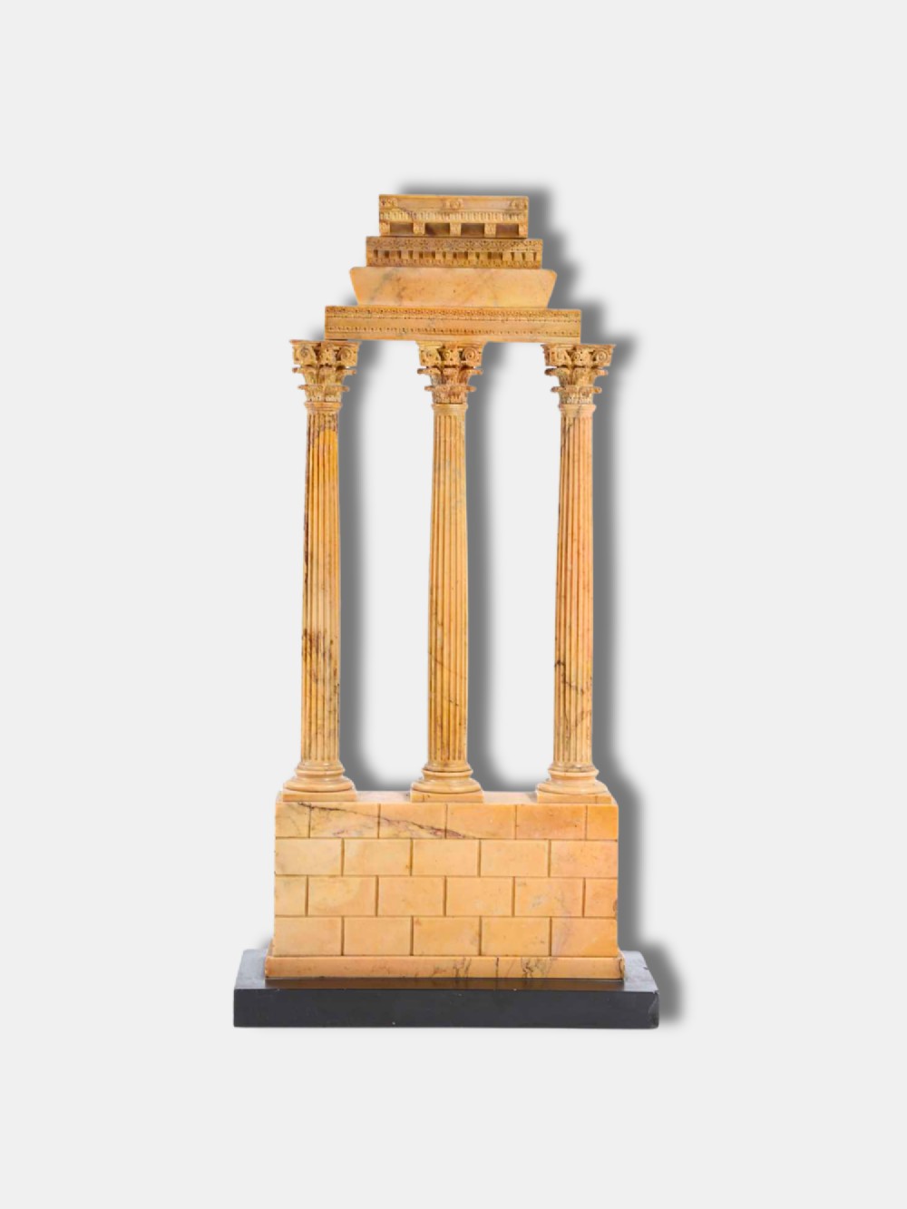 A yellow Giallo Antico marble model depicting three fluted Corinthian columns and entablature from the Temple of Castor and Pollux set on a black marble base. View II
