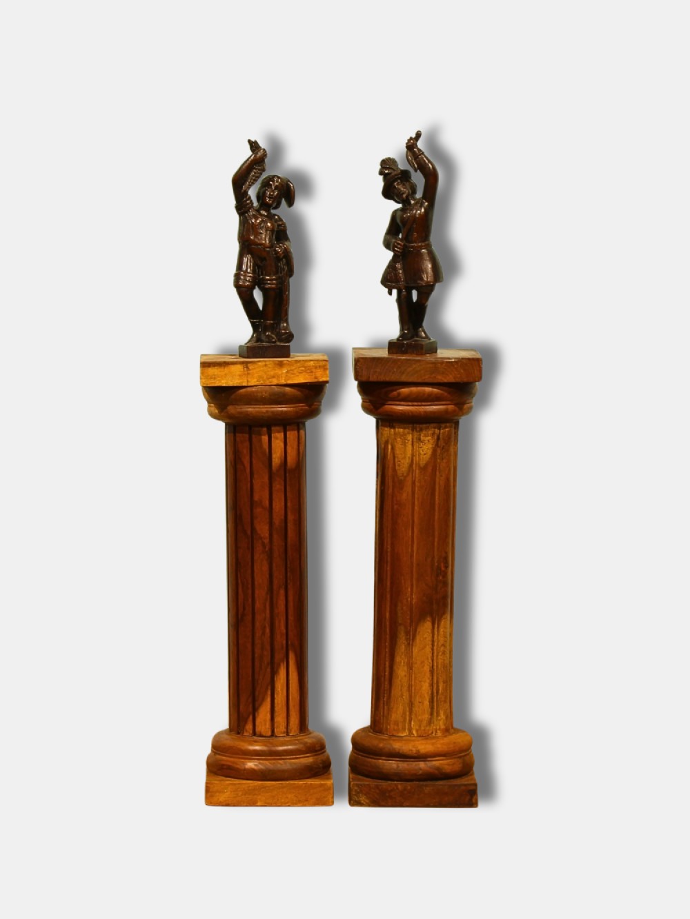 A pair of warm brown turned hardwood column pedestals featuring fluted shafts, square capital tops, and moulded square bases. View II