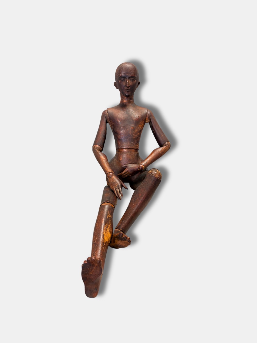 A French circa 1850 carved dark wood articulated artist lay figure shown in a seated position. View II