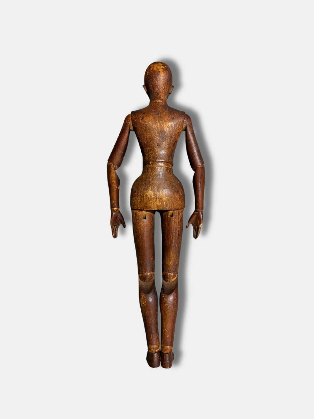 A French circa 1850 carved dark wood articulated artist lay figure shown in a seated position. View V
