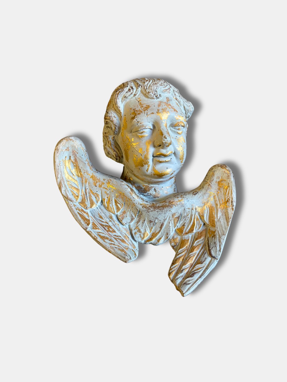 A pair of carved white and gilded French putti heads featuring winged detailing and distressed finishes. View II