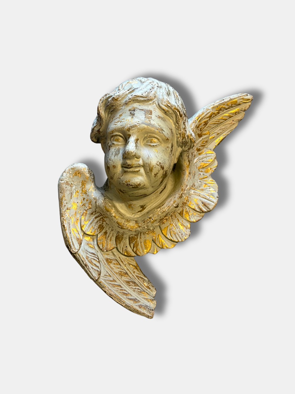 A pair of carved white and gilded French putti heads featuring winged detailing and distressed finishes. View III