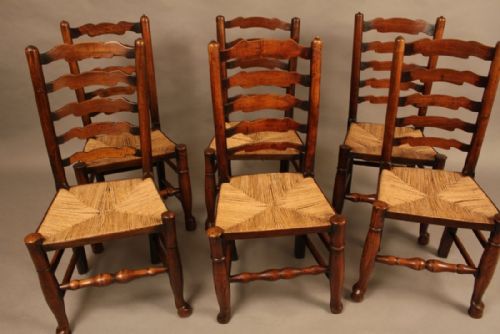 A Harlequin Set of Six 19th Century Ladder Back Chairs
