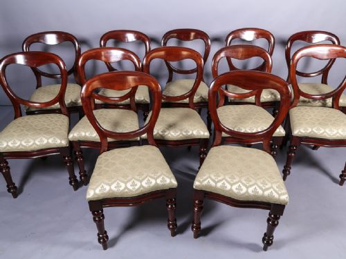 A Set of 12 Victorian Mahogany Balloon Back Dining Chairs