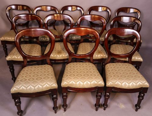 A Set of 12 Victorian Mahogany Balloon Back Dining Chairs