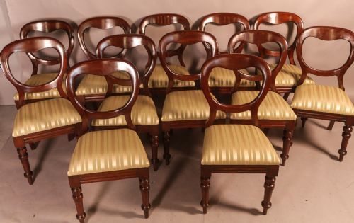 A Set of 12 Victorian Mahogany Balloon Back Dining Chairs