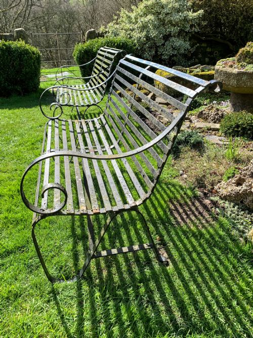 A RARE MATCHING PAIR OF WROUGHT IRON GARDEN BENCHES - ADDITIONAL PHOTO 3