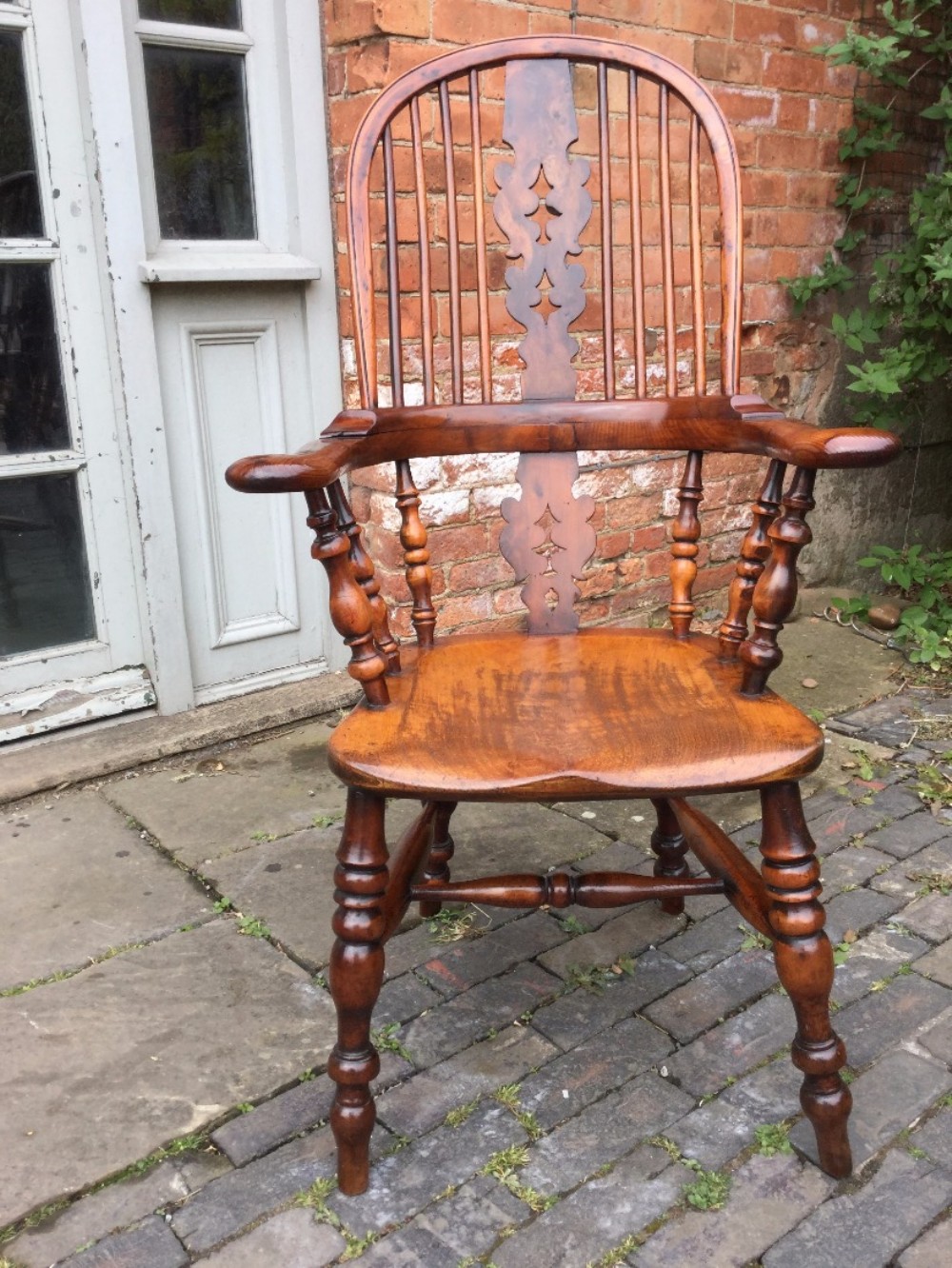 A Yew wood broad arm Windsor Chair 
