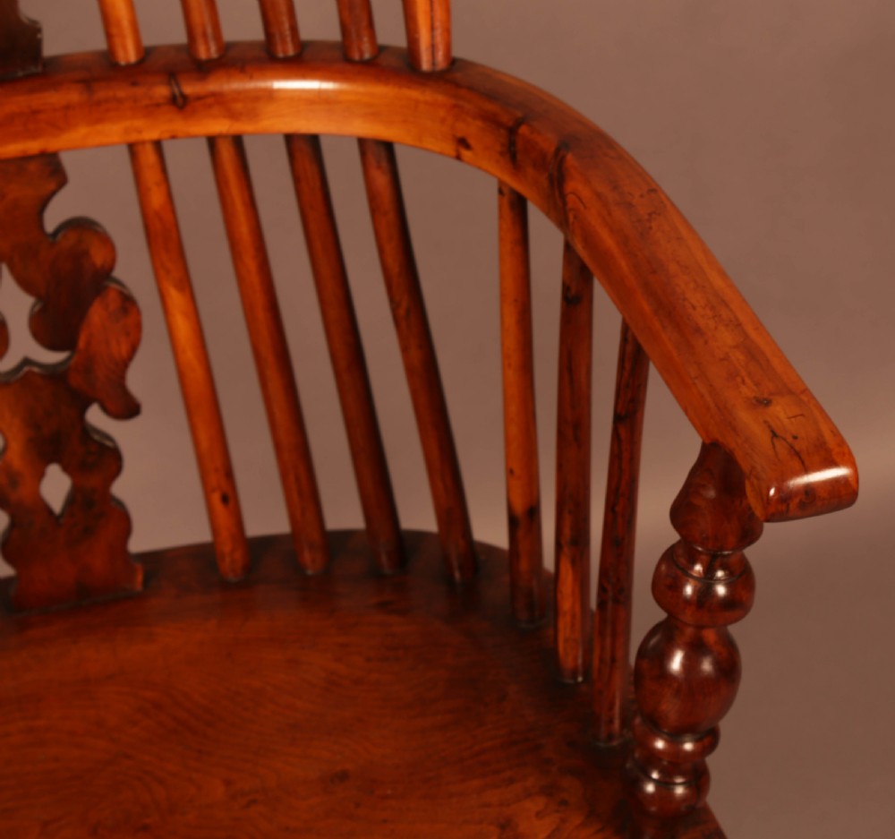 A mid-19th century high-back yew wood Windsor armchair featuring a pierced central splat, steam-bent armrests, shaped seat, and turned legs. View VII