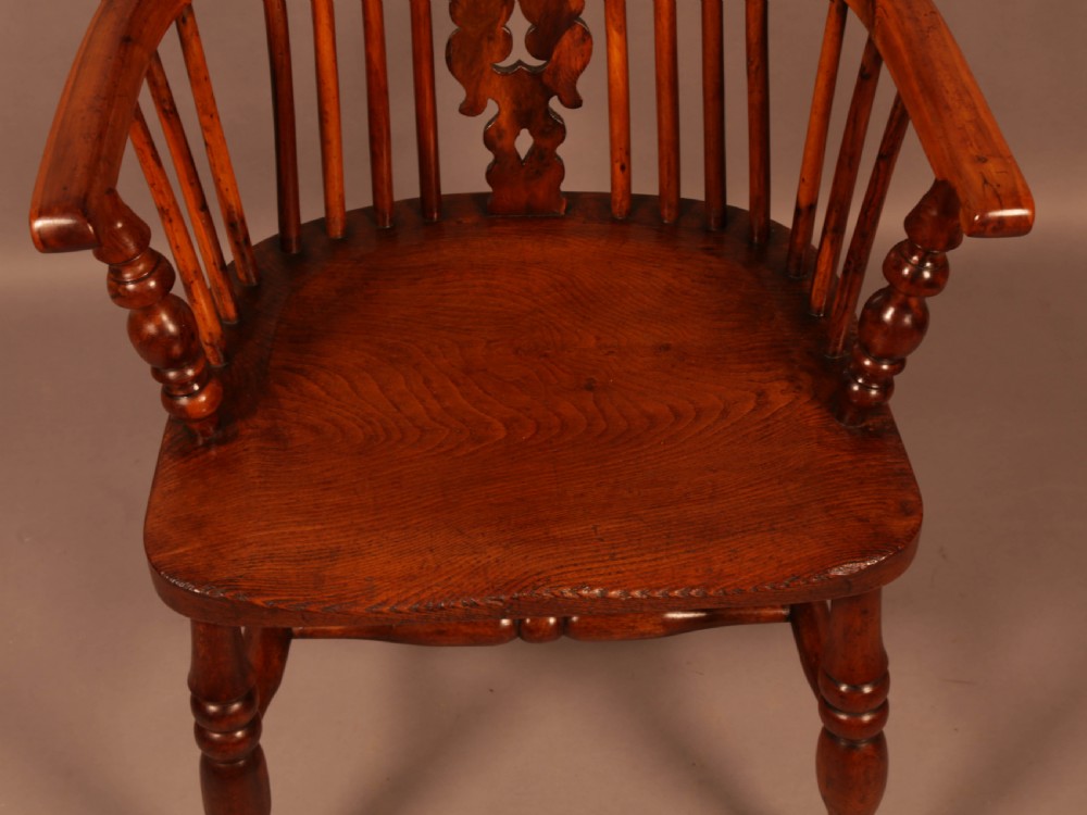 A mid-19th century high-back yew wood Windsor armchair featuring a pierced central splat, steam-bent armrests, shaped seat, and turned legs. View VIII
