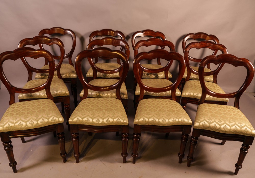 A Set of 12 Victorian Mahogany Balloon Back Dining Chairs