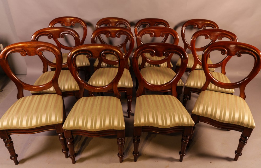 A Set of 12 Victorian Mahogany Balloon Back Dining Chairs