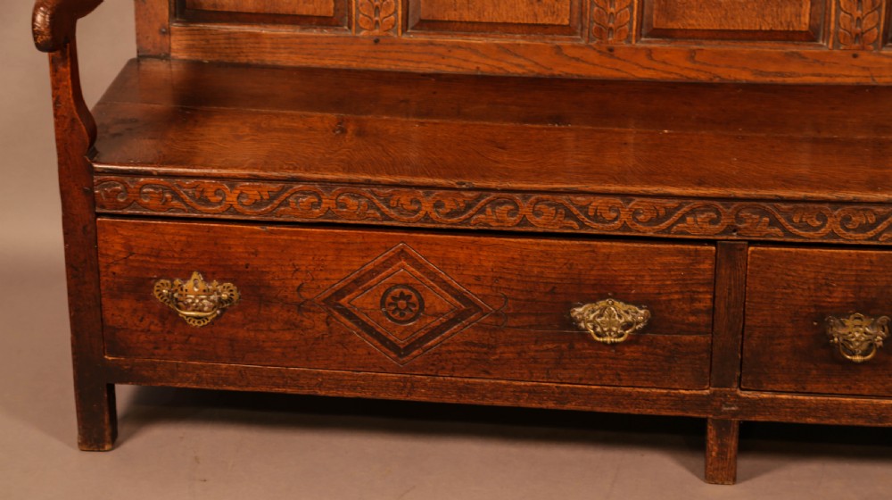 A Georgian Oak Settle with storage drawers View III