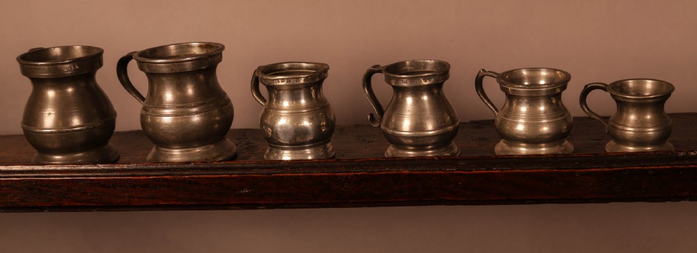 A collection of 6 pewter tankards antique View II