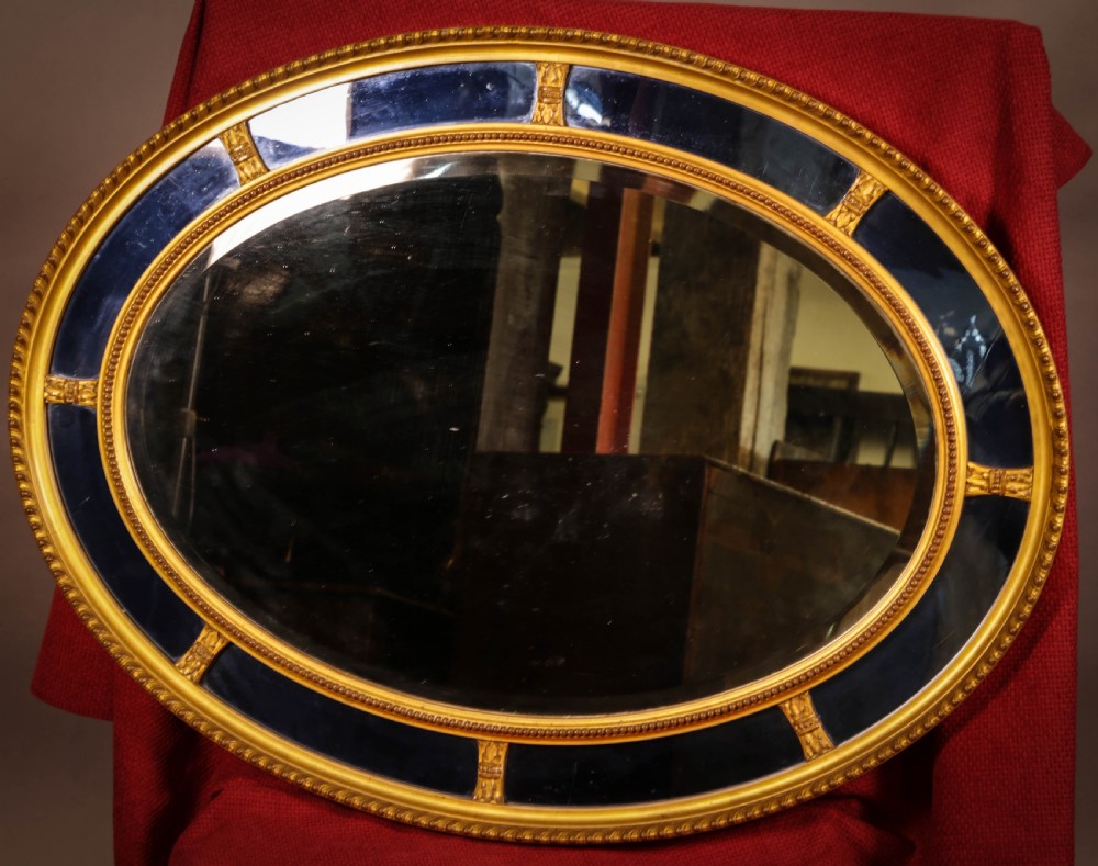 An Oval Mirror segmented with Blue Glass Rare
