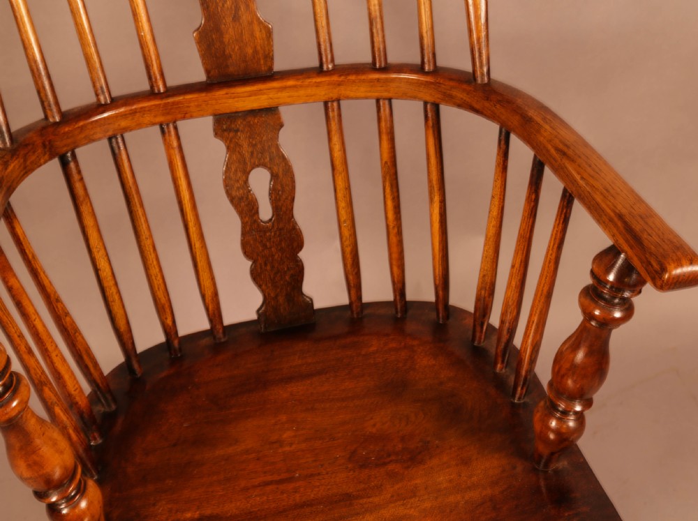 An antique high-back Windsor armchair crafted from ash and elm timber with turned legs and a pierced back splat. View VIII