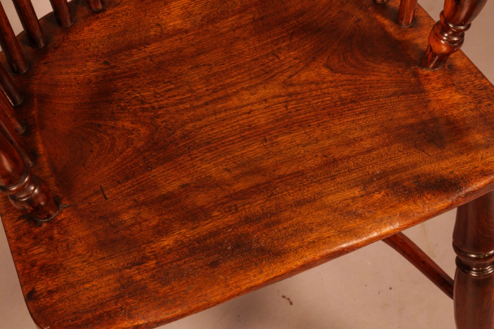 A high-backed wooden Windsor armchair featuring a pierced splat, slender spindles, and turned legs joined by an H-stretcher. View VIII