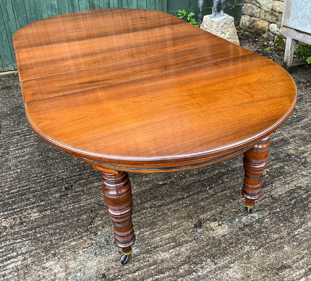 A Victorian 3 leaf Extending Dining Table in Walnut