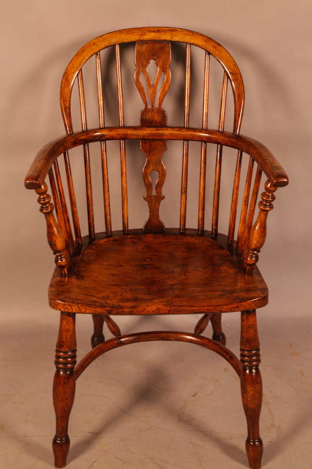 A traditional ash and elm low-back Windsor armchair with a shaped saddle seat, turned legs, and a steam-bent back hoop. View II