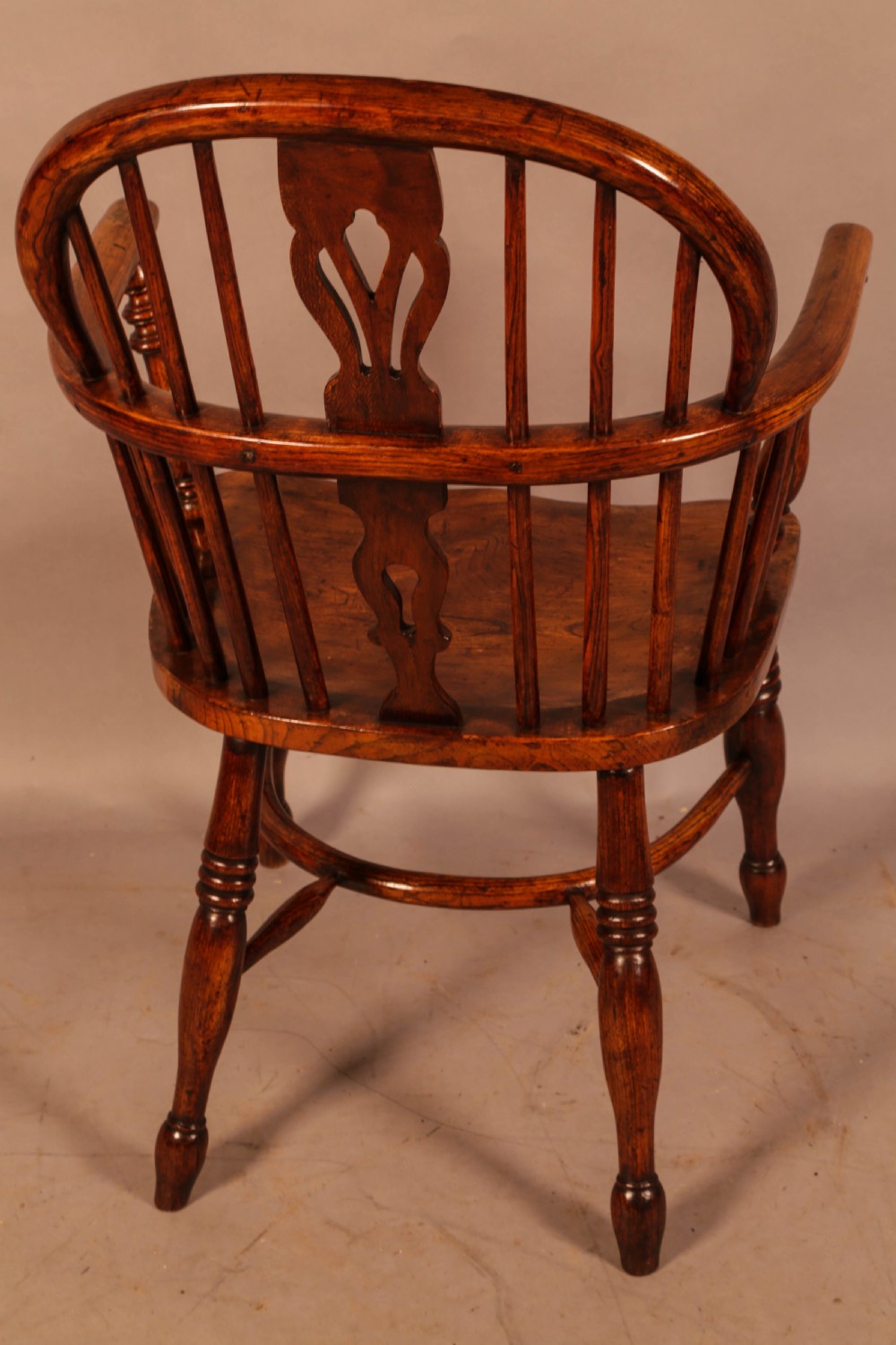 A traditional ash and elm low-back Windsor armchair with a shaped saddle seat, turned legs, and a steam-bent back hoop. View III