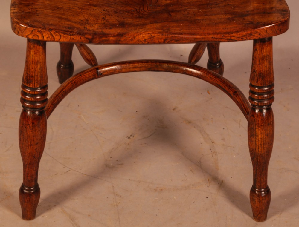 A traditional ash and elm low-back Windsor armchair with a shaped saddle seat, turned legs, and a steam-bent back hoop. View IV