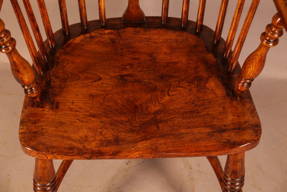 A traditional ash and elm low-back Windsor armchair with a shaped saddle seat, turned legs, and a steam-bent back hoop. View VII