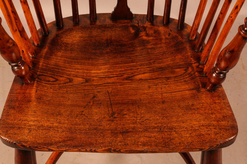 An antique yew wood low-back Windsor armchair featuring turned legs, a crinoline stretcher, and a pierced splat. View VIII