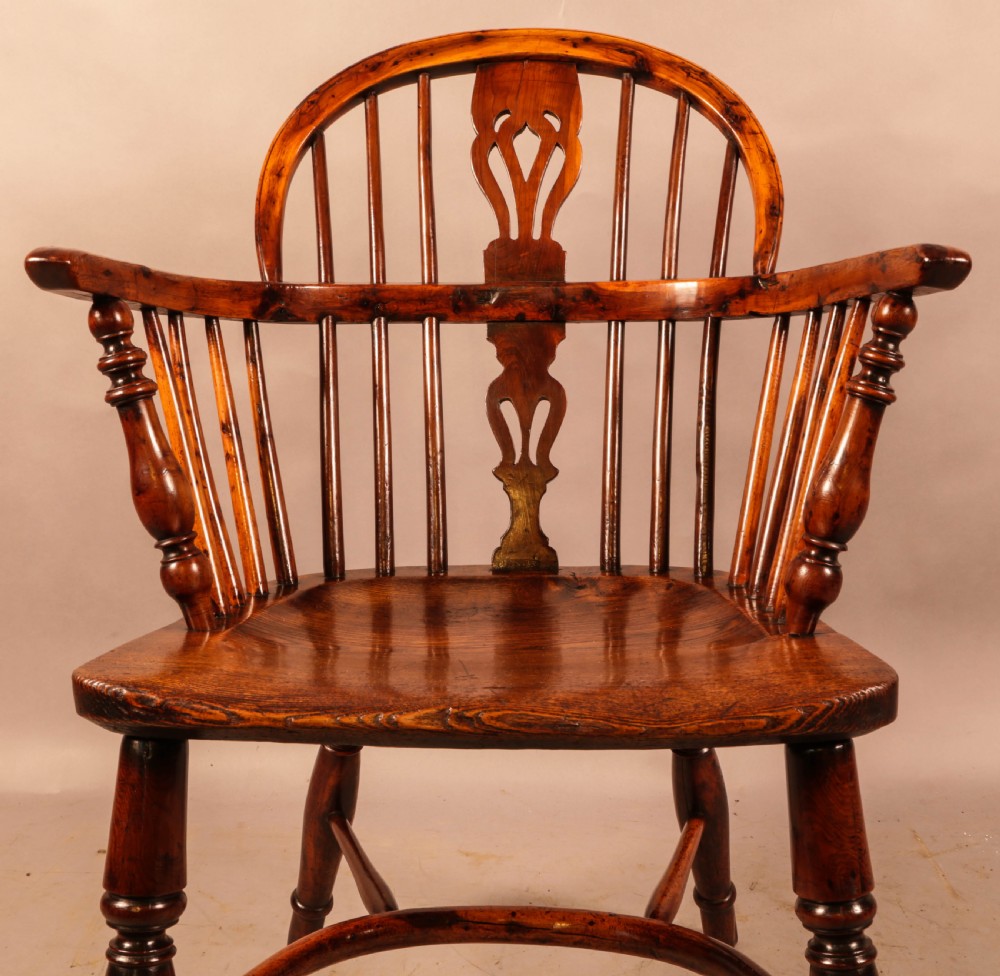 An antique yew wood low-back Windsor armchair featuring turned legs, a crinoline stretcher, and a pierced splat. View XII