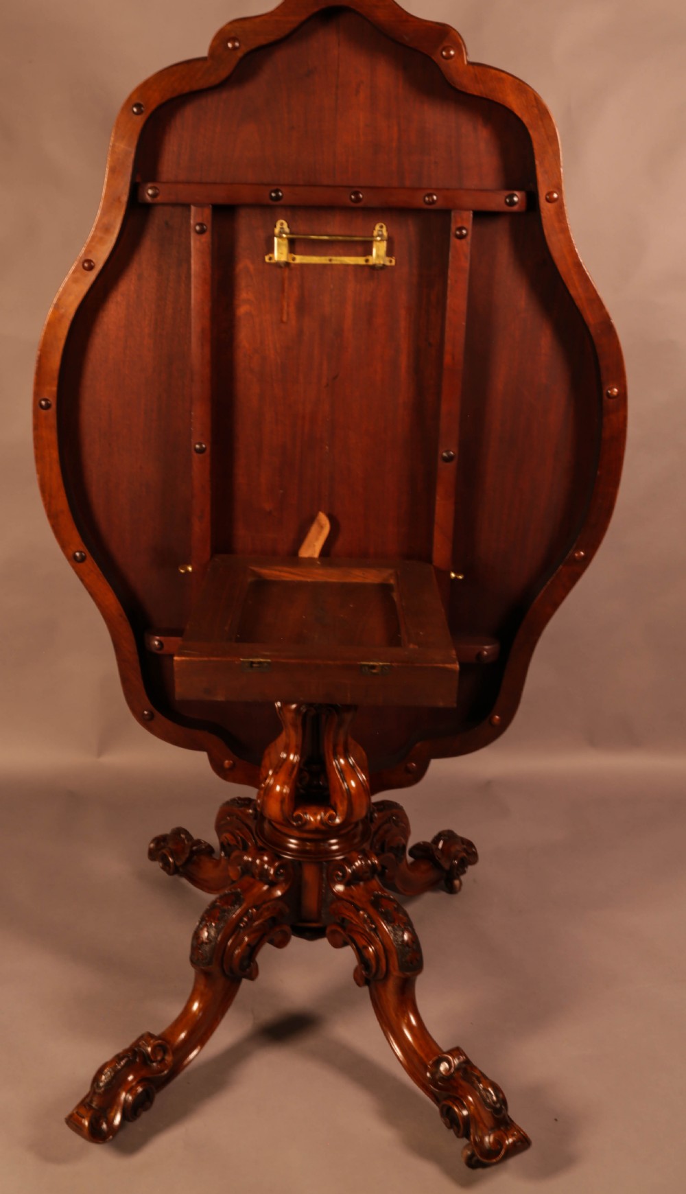 A Victorian burr walnut breakfast table featuring a shaped serpentine top resting on a central carved pedestal column with four scroll-carved legs. View IX