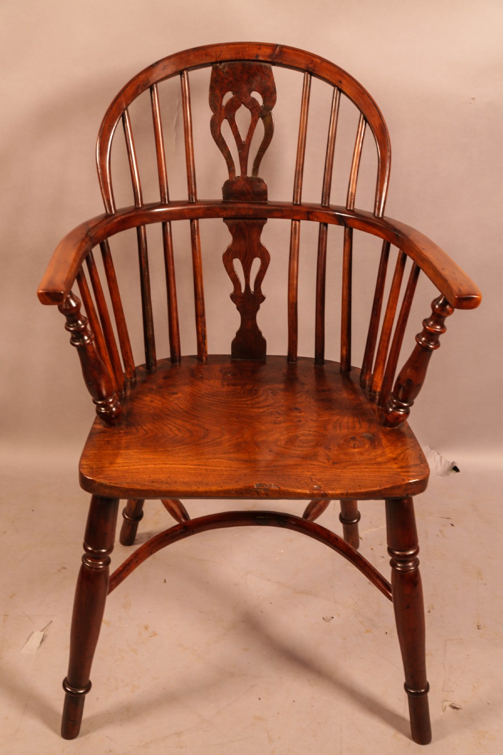 A low-back yew wood Windsor armchair featuring turned legs, a shaped seat, a pierced central back splat, and a curved crinoline stretcher. View II