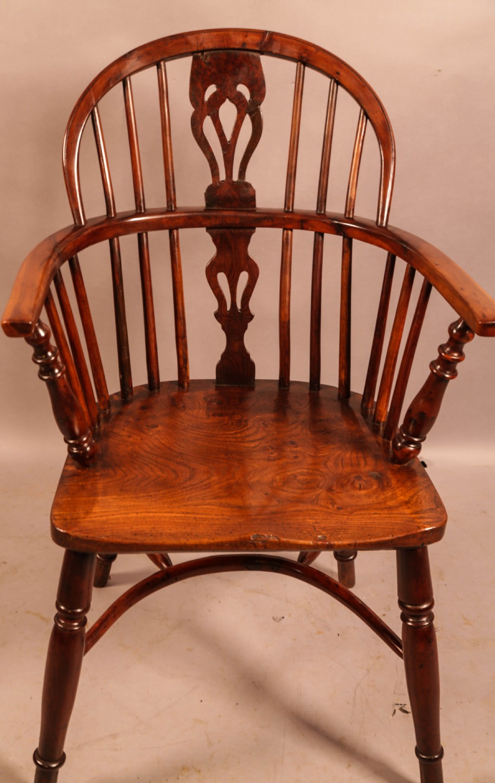 A low-back yew wood Windsor armchair featuring turned legs, a shaped seat, a pierced central back splat, and a curved crinoline stretcher. View IV