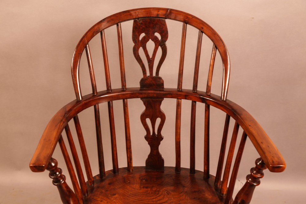A low-back yew wood Windsor armchair featuring turned legs, a shaped seat, a pierced central back splat, and a curved crinoline stretcher. View VI