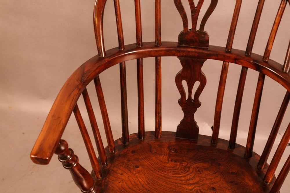 A low-back yew wood Windsor armchair featuring turned legs, a shaped seat, a pierced central back splat, and a curved crinoline stretcher. View VIII