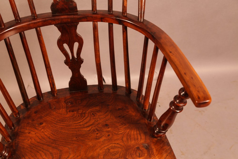 A low-back yew wood Windsor armchair featuring turned legs, a shaped seat, a pierced central back splat, and a curved crinoline stretcher. View IX